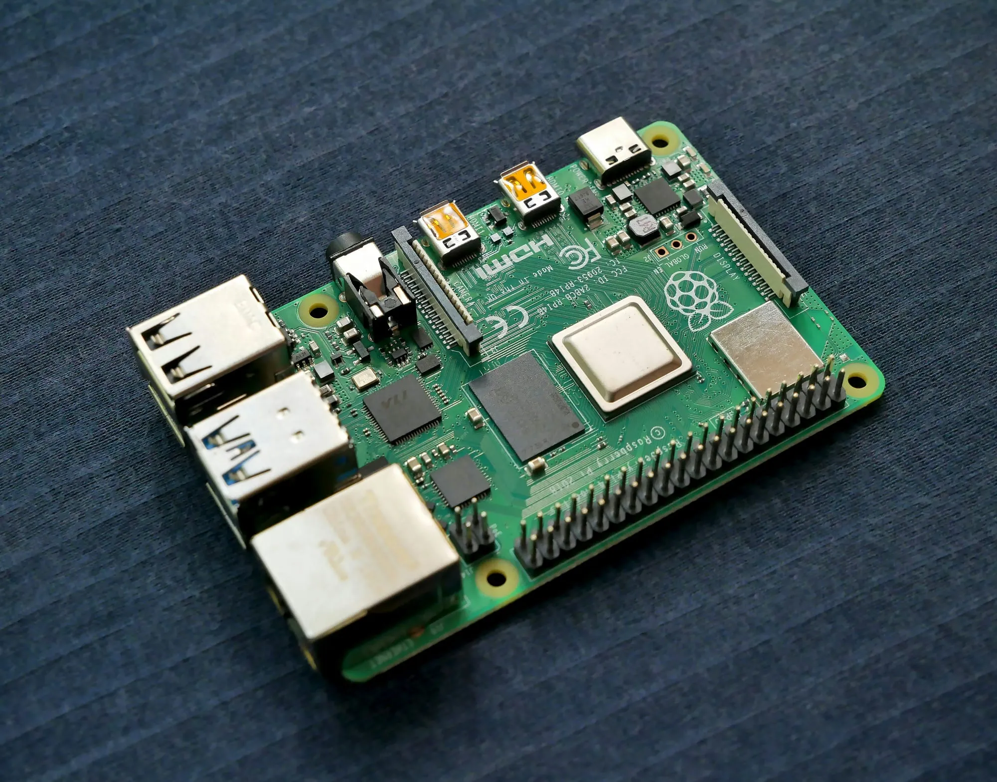 Top-down view of a Raspberry Pi 4 single-board computer, showing the SoC, USB and Ethernet ports and the GPIO header along one edge